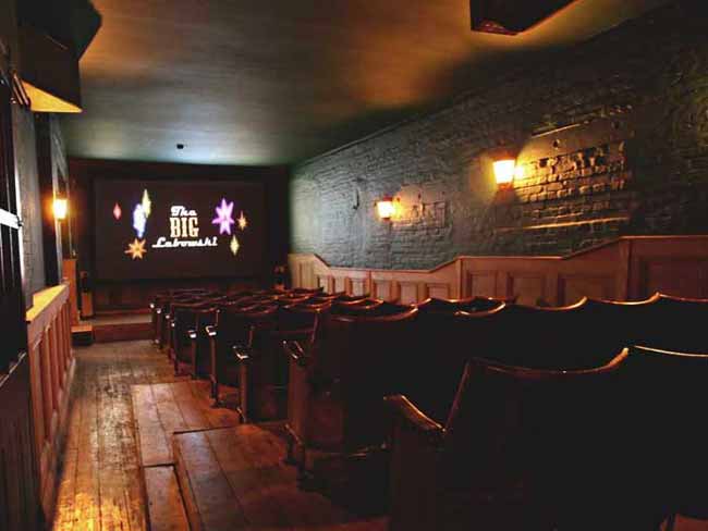 View of empty cinema seats and a large screen